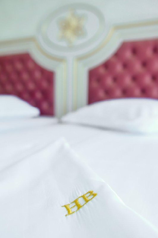 Lenjerie albă cu monograma HB brodată, la Hotel Belona